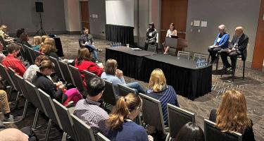 Horizontal photo of four panelists speaking at the P I O session at Sci Wri 24