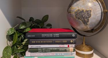 Rectangular photo of Kavin Senapathy office bookshelf showing works on child care, racism, feminism, and body image. Photo credit: Kavin Senapathy. 