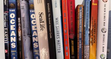 Rectangular photo of Ellen Prager office bookshelf showing works on oceans, sea life, and climate change. Photo credit: Ellen Prager