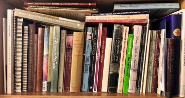 Rectangular photo of Wynne Brown's book shelf with titles about women in the U.S. West. Photo credit Wynne Brown.