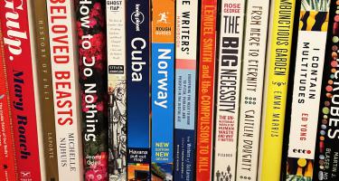 Photo of bookshelf in Bryn Nelson's office showing some of the reference books for his book, Flush.
