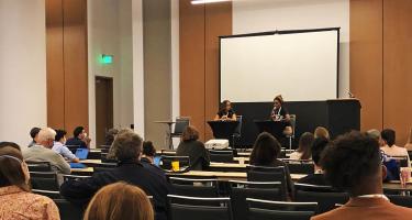 Horizontal photo of Wendi C. Thomas and Ayanna Hampton in conversation on stage at the Science Writers 2022 annual meeting in Memphis, with seated attendees in the foreground