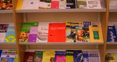 Science journals on bookshelf