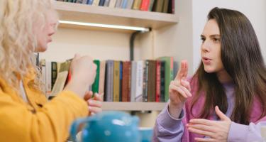 Women conversing in sign language