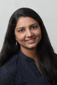 Studio portrait photo of Jyoti Madhusoodanan smiling