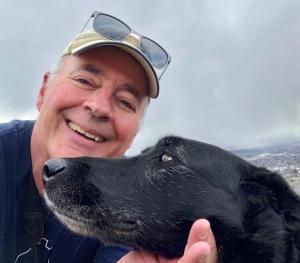 Portrait photo of Sneed B. Collard III and his dog Lola