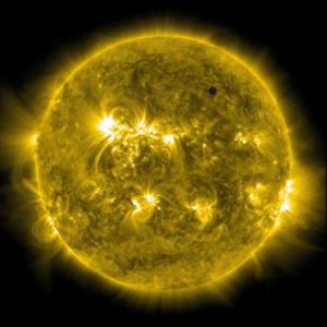 Venus is nearly lost in solar chaos in this photo of the far ultraviolet spectrum. Credit:NASA Solar Dynamic Observatory.