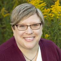 Portrait photo of Jessica Fries-Gaither in an outdoor setting.