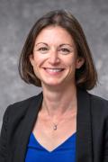 Studio portrait photo of Kelly Tyrrell wearing a blazer and blouse