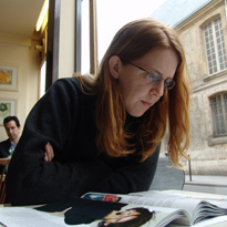 Robin reading in a Paris Cafe